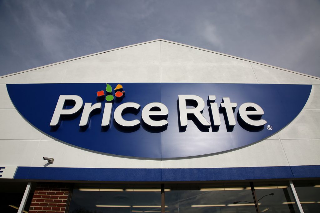 Exterior view of a Price Rite Marketplace store showing the large, curved blue and white storefront sign with the company logo prominently displayed against the building facade.
