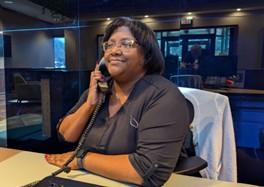 Sherhonda from Work Hard Dress Right providing customer support over the phone for uniform program clients.