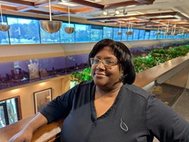 Sherhonda from Work Hard Dress Right standing on the mezzanine at Feury Image Group headquarters in NJ.