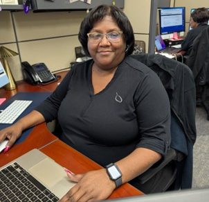 Sherhonda at her desk managing online and uniform program orders for Work Hard Dress Right clients.