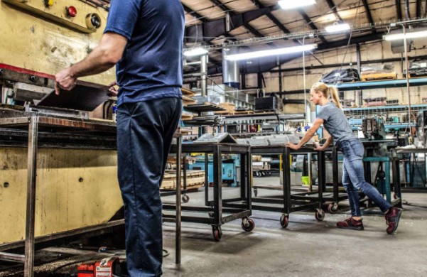 industrial workers wearing safety work boots in manufacturing workshop