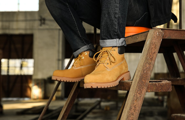 construction worker wearing protective work boots on industrial jobsite stairs