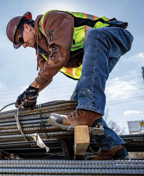Construction worker wearing high visibility uniform working on job site