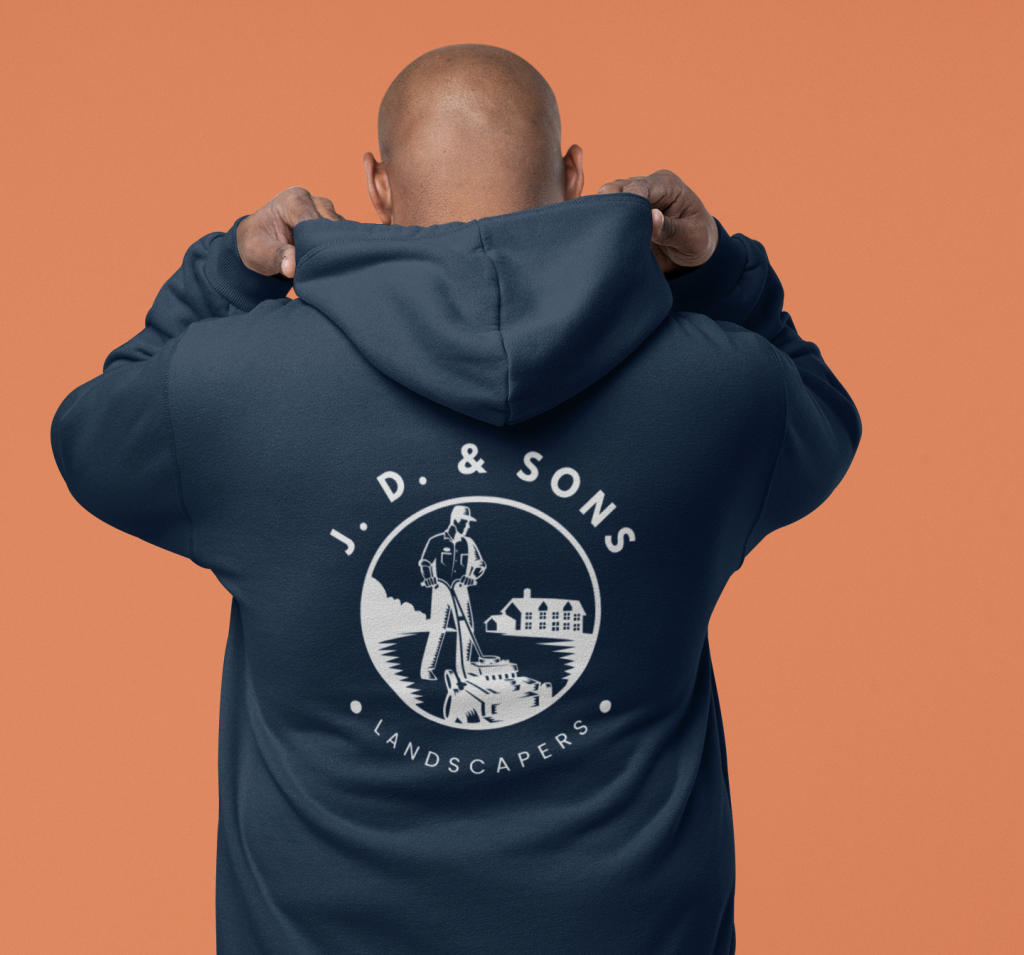Worker wearing custom branded hoodie with landscaping company logo on back