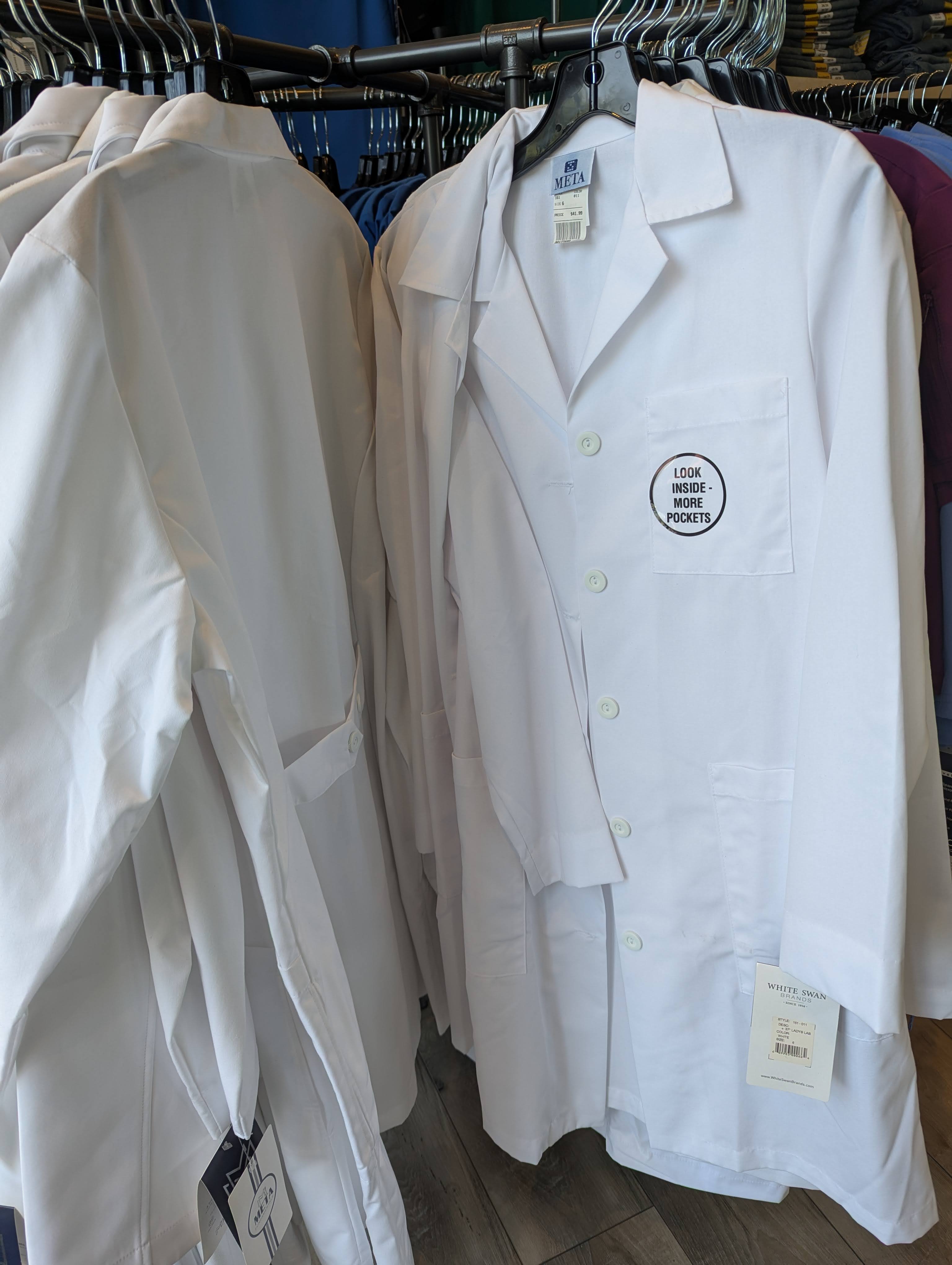 White professional lab coats on display at the Newark store
